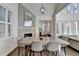 Spacious dining area with fireplace, a large wooden table, and bright natural light at 3355 Olivia Ct, Cumming, GA 30041