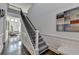 Spacious foyer with hardwood floors, a staircase with iron railings, and a view of the living room at 3355 Olivia Ct, Cumming, GA 30041