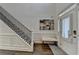 Light-filled foyer with hardwood floors, a staircase with iron railings, and an elegant bench at 3355 Olivia Ct, Cumming, GA 30041