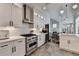 Modern white kitchen with stainless steel appliances, white subway tile, and views to the dining area at 3355 Olivia Ct, Cumming, GA 30041