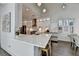 Open kitchen with white cabinets, marble countertops, stainless steel appliances, and a breakfast bar at 3355 Olivia Ct, Cumming, GA 30041
