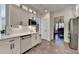 This spacious kitchen features white cabinets and appliances, with a view to the staircase at 3355 Olivia Ct, Cumming, GA 30041