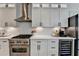 This kitchen features white cabinets, stainless steel appliances, and a modern tile backsplash at 3355 Olivia Ct, Cumming, GA 30041
