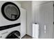 Clean laundry area with stacked washer and dryer; storage at 3355 Olivia Ct, Cumming, GA 30041