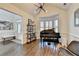 Inviting living room with piano, bay window, modern lighting and stylish decor elements at 3355 Olivia Ct, Cumming, GA 30041