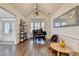 Bright living room with a piano, bay window, stylish decor, and ample natural light at 3355 Olivia Ct, Cumming, GA 30041