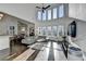 Sun-drenched living room with high ceilings, stylish gray sectional, and sleek entertainment center at 3355 Olivia Ct, Cumming, GA 30041