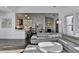 Open-concept living room with views of the kitchen, a stone fireplace, and hardwood floors at 3355 Olivia Ct, Cumming, GA 30041