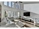 Bright living room with soaring ceilings, large windows, and comfortable seating at 3355 Olivia Ct, Cumming, GA 30041