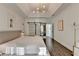 Bright main bedroom featuring tray ceiling and modern light fixture with wood-look floors at 3355 Olivia Ct, Cumming, GA 30041