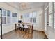 Bright home office featuring a desk under many windows with stylish light fixture at 3355 Olivia Ct, Cumming, GA 30041