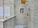 Modern shower with glass doors and gray subway tile with gold fixtures at 3355 Olivia Ct, Cumming, GA 30041