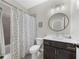 Cozy bathroom featuring a single vanity, modern light fixture, and a shower-tub combination at 6370 Cortland Walk, Alpharetta, GA 30005