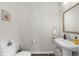 Clean and simple powder room with a pedestal sink and a framed mirror at 6370 Cortland Walk, Alpharetta, GA 30005