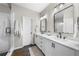 Bathroom featuring a double vanity, sleek black fixtures, and a glass-enclosed shower at 6370 Cortland Walk, Alpharetta, GA 30005
