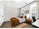 Cozy bedroom with natural light, a bed with a brown comforter, and a small workspace at 6370 Cortland Walk, Alpharetta, GA 30005