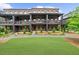 Charming three-story brick townhome with manicured lawn and covered front porches at 6370 Cortland Walk, Alpharetta, GA 30005