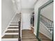 Well-lit hallway with staircase, large decorative mirror and convenient closet space at 6370 Cortland Walk, Alpharetta, GA 30005