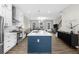 Bright kitchen with white cabinets, stainless steel appliances, and a large island with seating at 6370 Cortland Walk, Alpharetta, GA 30005