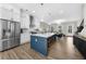 Modern kitchen with stainless steel appliances, island with breakfast bar, and open layout at 6370 Cortland Walk, Alpharetta, GA 30005