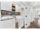 Well-organized laundry room with overhead cabinets, washer, and dryer hookups at 6370 Cortland Walk, Alpharetta, GA 30005