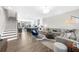 Open-concept living space with kitchen, dining, and living areas, featuring a staircase at 6370 Cortland Walk, Alpharetta, GA 30005