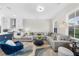 Open-concept living space with kitchen, dining, and living areas, featuring a large sectional sofa at 6370 Cortland Walk, Alpharetta, GA 30005