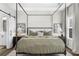 Bedroom with four-poster bed, two windows, two side tables, and bathroom access through barn door at 6370 Cortland Walk, Alpharetta, GA 30005