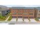 Row of brick townhomes with attached garages and well-manicured landscaping at 6370 Cortland Walk, Alpharetta, GA 30005
