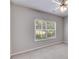 Neutral bedroom with large window offering outdoor views and a modern ceiling fan at 7712 Autry Cir # 701, Douglasville, GA 30134