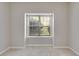 Bright bedroom featuring neutral walls, carpeted floors, and a large window at 7712 Autry Cir # 701, Douglasville, GA 30134
