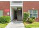 Exterior staircase with brick facade, building numbers, adjacent landscaping, and private parking signs at 7712 Autry Cir # 701, Douglasville, GA 30134