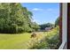 View of community pool area with green space, mature trees, and red brick community center on a sunny day at 7712 Autry Cir # 701, Douglasville, GA 30134