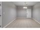 Open dining room featuring tile floors, a modern light fixture, and neutral wall paint at 7712 Autry Cir # 701, Douglasville, GA 30134