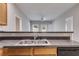 Kitchen featuring granite countertops, a stainless steel sink, and an open view into the adjacent living area at 7712 Autry Cir # 701, Douglasville, GA 30134