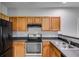 Well-equipped kitchen featuring modern appliances, light wood cabinets and dark countertops at 7712 Autry Cir # 701, Douglasville, GA 30134