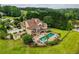 Stunning home featuring a swimming pool, patio, and lush landscaping in a serene, wooded setting at 2675 Portabella Ln, Cumming, GA 30041