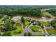 Expansive aerial view showcasing a community of homes nestled around a serene lake surrounded by lush greenery at 2675 Portabella Ln, Cumming, GA 30041