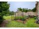 Backyard featuring a garden area, shed, manicured lawn, and mature trees create a private outdoor space at 2675 Portabella Ln, Cumming, GA 30041