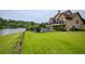 Lakeside home showcasing a pool, balcony, and spacious yard, perfect for enjoying outdoor living and recreation at 2675 Portabella Ln, Cumming, GA 30041