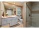 Bright bathroom showcasing a glass shower, vanity, toilet, and a window for natural light at 2675 Portabella Ln, Cumming, GA 30041
