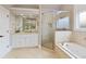 Well-appointed bathroom featuring a walk-in shower, a soaking tub, and a vanity with drawers at 2675 Portabella Ln, Cumming, GA 30041