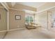 Neutral bedroom with a sitting area near a window, offering a calm and inviting space at 2675 Portabella Ln, Cumming, GA 30041
