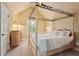 Cozy bedroom with a four-poster bed, neutral walls, and lots of natural light at 2675 Portabella Ln, Cumming, GA 30041