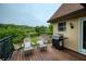 Cozy deck area with chairs and a grill, perfect for outdoor dining and enjoying the lake view at 2675 Portabella Ln, Cumming, GA 30041