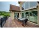 Outdoor deck with dining table offering beautiful views of the lake and the home's architecture at 2675 Portabella Ln, Cumming, GA 30041