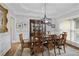 Elegant dining room with hardwood floors, decorative molding, and large windows at 2675 Portabella Ln, Cumming, GA 30041