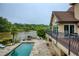 Multi-level deck and patio showcase outdoor living spaces, pool, and scenic lake views at 2675 Portabella Ln, Cumming, GA 30041