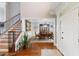 Spacious foyer featuring hardwood floors, staircase and an open view to the dining room at 2675 Portabella Ln, Cumming, GA 30041