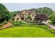 Charming two-story home featuring a well-manicured lawn, lush landscaping, and a winding walkway at 2675 Portabella Ln, Cumming, GA 30041
